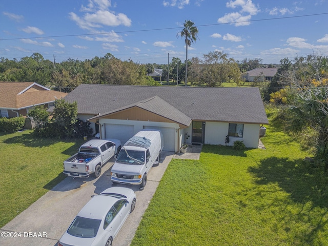 single story home with a garage and a front lawn