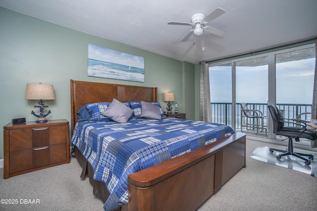3311 S Atlantic Ave Unit 602, Daytona Beach Shores, FL 32118 - bedroom with carpet floors, access to exterior, a ceiling fan, and floor to ceiling windows