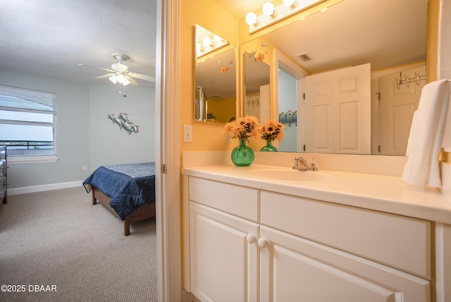 3311 S Atlantic Ave Unit 602, Daytona Beach Shores, FL 32118 - bathroom featuring vanity, ceiling fan, baseboards, and ensuite bath
