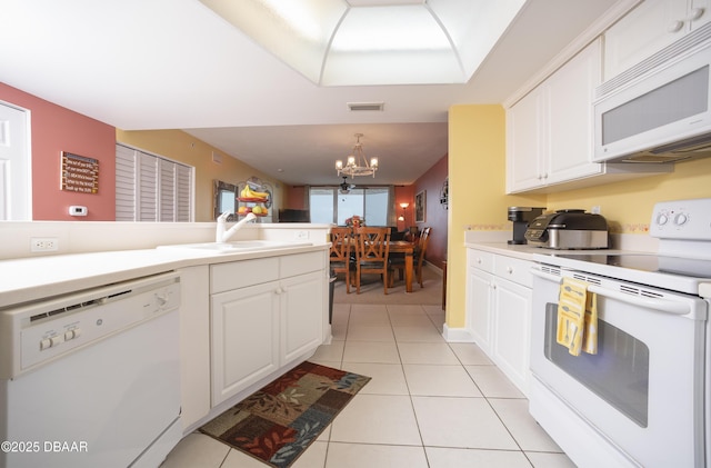 3311 S Atlantic Ave Unit 602, Daytona Beach Shores, FL 32118 - dining area with a chandelier, light carpet, ceiling fan, and baseboards