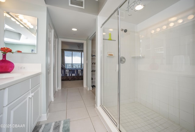 3311 S Atlantic Ave Unit 602, Daytona Beach Shores, FL 32118 - bathroom with vanity, a shower stall, tile patterned flooring, a walk in closet, and recessed lighting