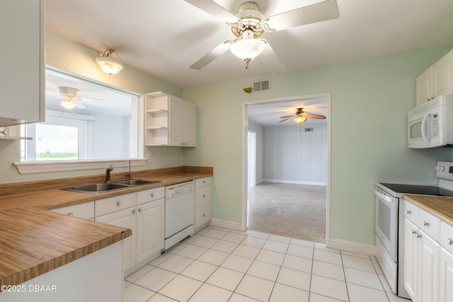 3622 Ocean Shore Blvd, Ormond Beach, FL 32176 - kitchen featuring white appliances, ceiling fan, and white cabinets