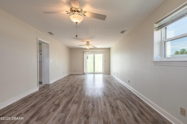 3622 Ocean Shore Blvd, Ormond Beach, FL 32176 - unfurnished room featuring a ceiling fan, wood finished floors, and a textured ceiling