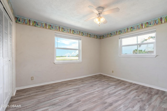 3622 Ocean Shore Blvd, Ormond Beach, FL 32176 - unfurnished bedroom featuring a closet, a textured ceiling, wood finished floors, and ceiling fan