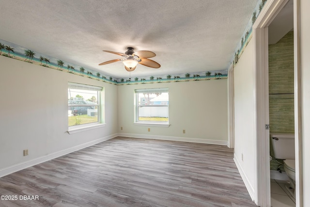 3622 Ocean Shore Blvd, Ormond Beach, FL 32176 - unfurnished room featuring a textured ceiling, ceiling fan, and light wood-type flooring