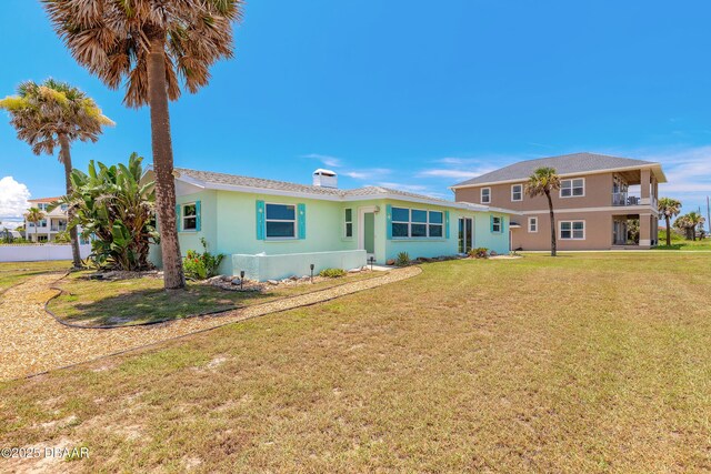 3622 Ocean Shore Blvd, Ormond Beach, FL 32176 - rear view of property featuring a yard, stucco siding, and a balcony