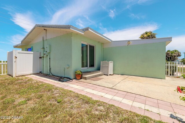 3622 Ocean Shore Blvd, Ormond Beach, FL 32176 - rear view of house featuring a patio area and stucco siding