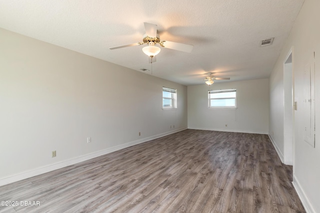 3622 Ocean Shore Blvd, Ormond Beach, FL 32176 - empty room featuring wood finished floors, ceiling fan, and a textured ceiling