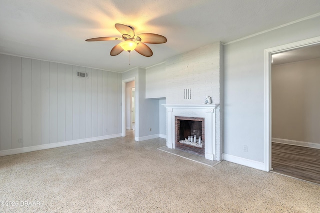 3622 Ocean Shore Blvd, Ormond Beach, FL 32176 - unfurnished living room featuring a fireplace, ceiling fan, speckle patterned floor, and crown molding