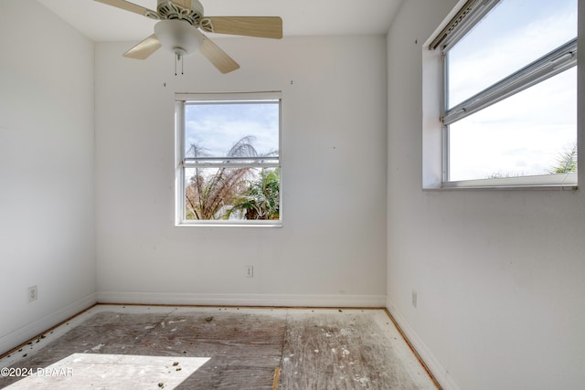 spare room with ceiling fan and a healthy amount of sunlight