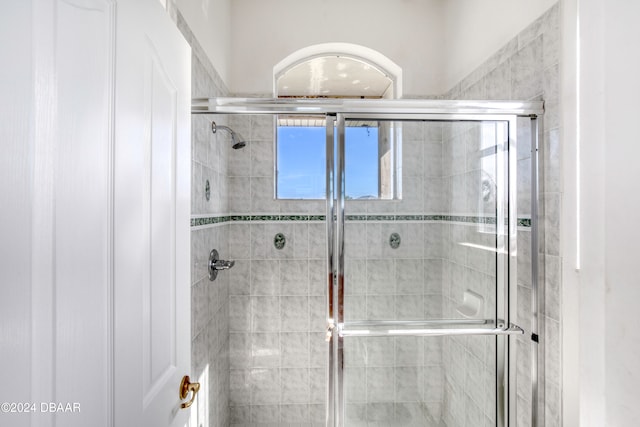 bathroom featuring a shower with door