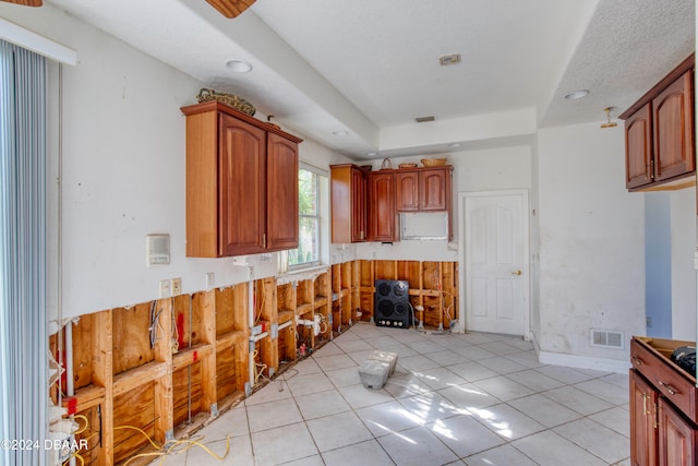 kitchen featuring a textured ceiling and light tile patterned floors