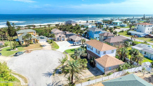 bird's eye view featuring a water view and a beach view