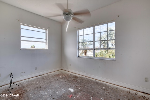 empty room featuring a wealth of natural light and ceiling fan