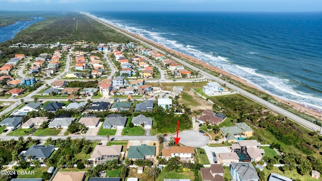 drone / aerial view featuring a beach view and a water view