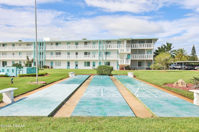 view of property's community with a yard