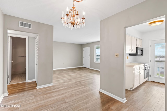 interior space featuring light hardwood / wood-style floors and an inviting chandelier