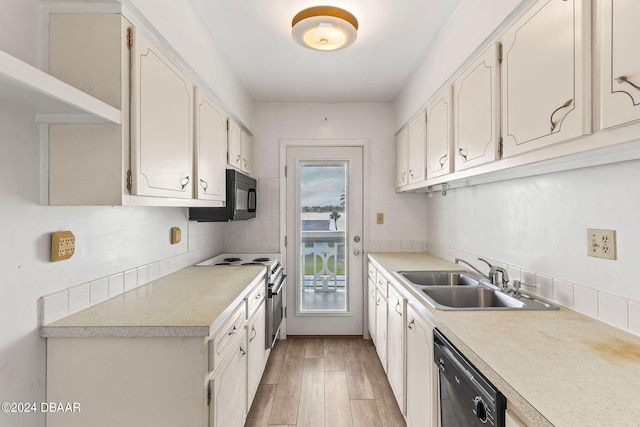 kitchen featuring black appliances, sink, light wood-type flooring, tasteful backsplash, and white cabinetry