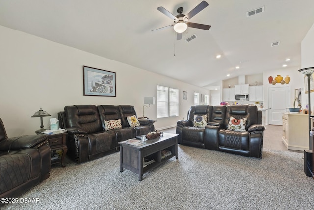 carpeted living room featuring ceiling fan and lofted ceiling