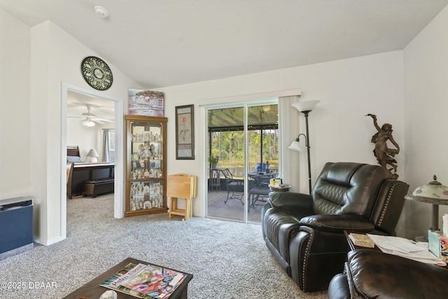 living room with ceiling fan, carpet, and vaulted ceiling