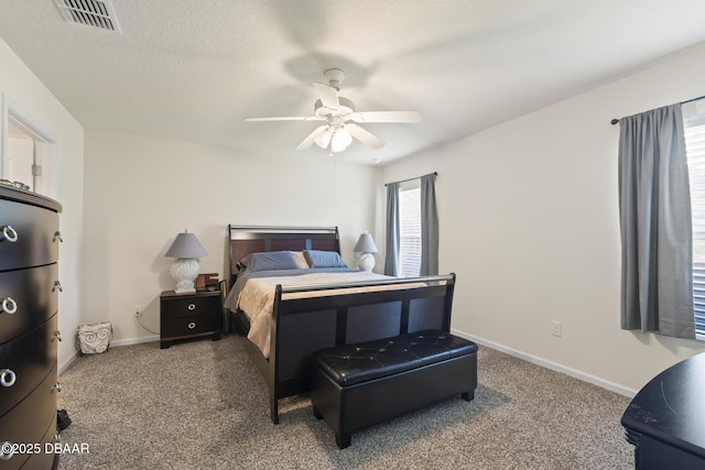 bedroom featuring carpet flooring, ceiling fan, and a textured ceiling