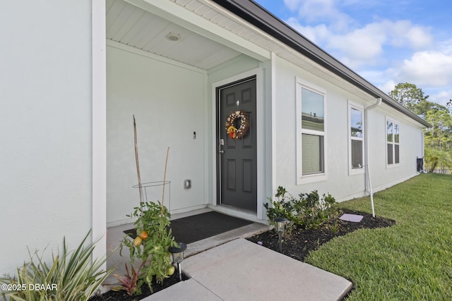 doorway to property with a yard