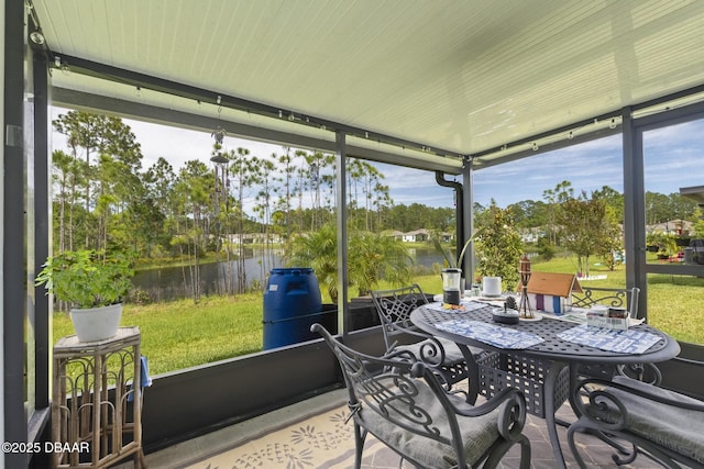 sunroom / solarium featuring a water view