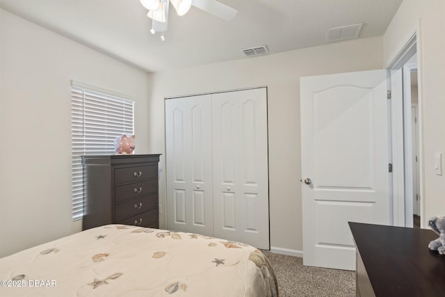 carpeted bedroom with ceiling fan and a closet