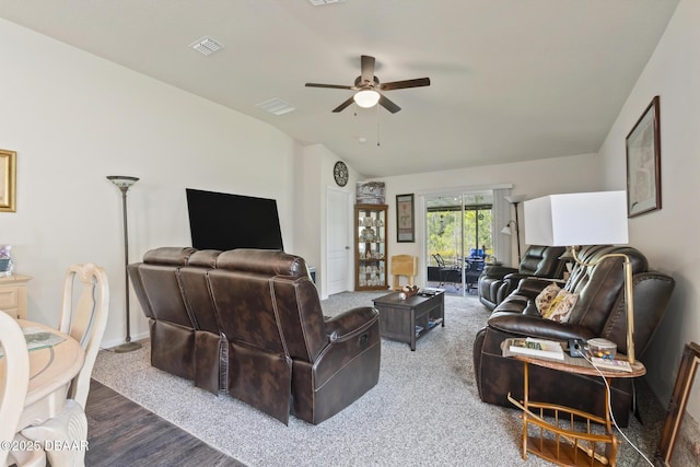 living room with ceiling fan, hardwood / wood-style floors, and vaulted ceiling