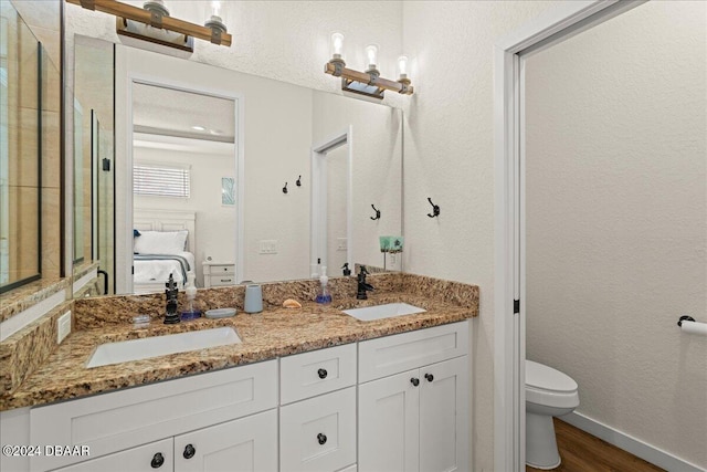 bathroom featuring hardwood / wood-style floors, vanity, and toilet