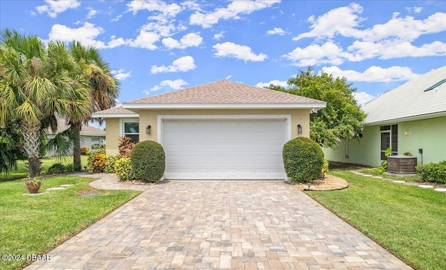 view of front of property featuring a front lawn and a garage