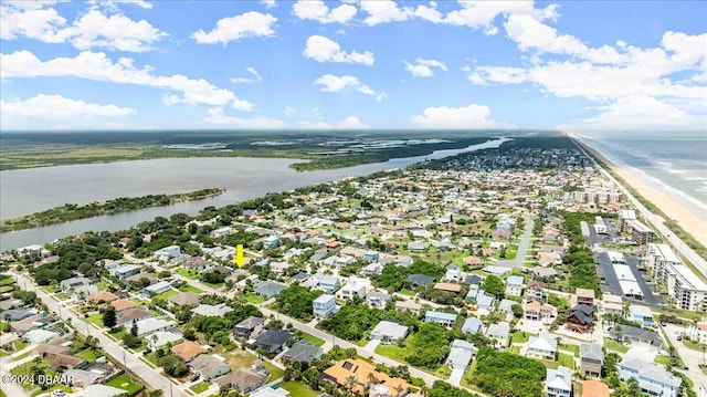 birds eye view of property featuring a view of the beach and a water view