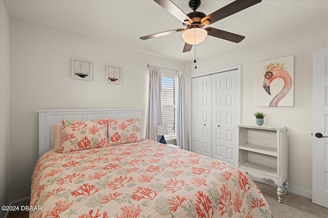 carpeted bedroom featuring a textured ceiling, ceiling fan, and a closet