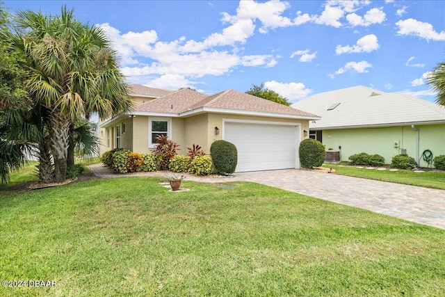 ranch-style house featuring a front lawn and a garage