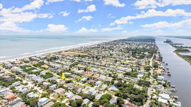 birds eye view of property with a view of the beach and a water view