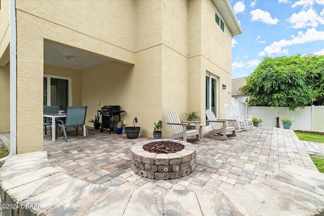 view of patio / terrace with a grill and a fire pit