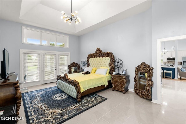 bedroom featuring a high ceiling, a notable chandelier, light tile patterned flooring, and a raised ceiling