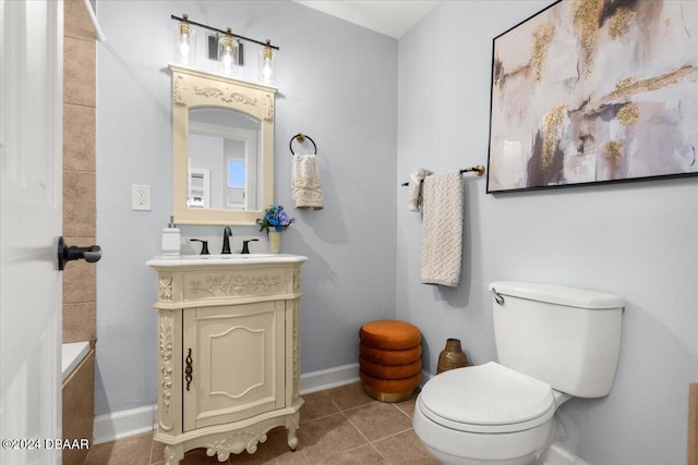 bathroom with tile patterned flooring, vanity, and toilet