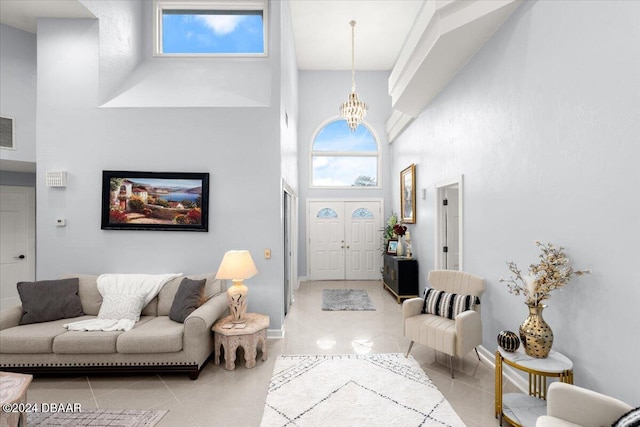 tiled foyer entrance featuring a high ceiling and a notable chandelier