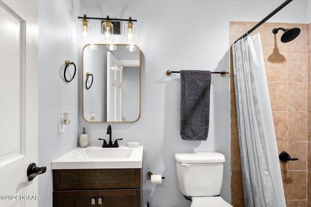 bathroom featuring toilet, vanity, and a shower with shower curtain