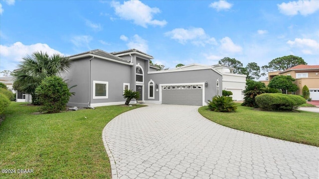 view of front of house featuring a garage and a front yard