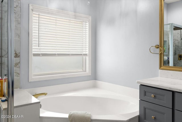 bathroom with vanity, plenty of natural light, and plus walk in shower