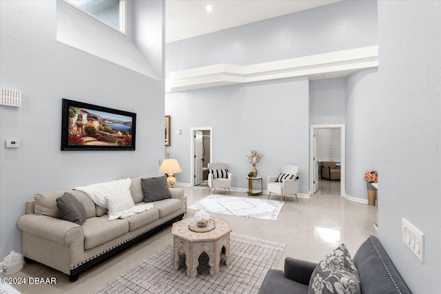 living room featuring a towering ceiling