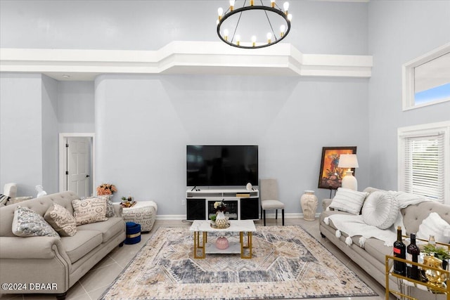 tiled living room featuring a towering ceiling and a chandelier