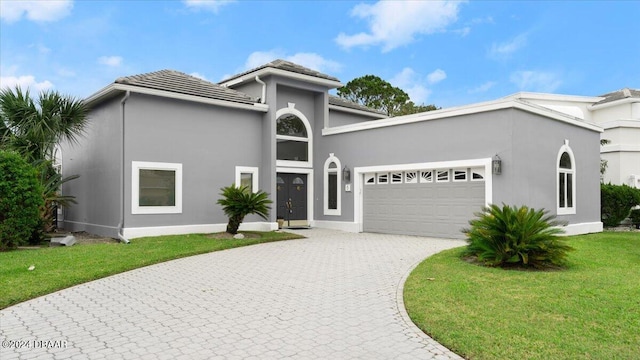 view of front of home with a garage and a front yard