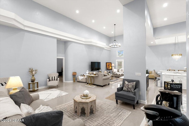 living room with a high ceiling and a chandelier