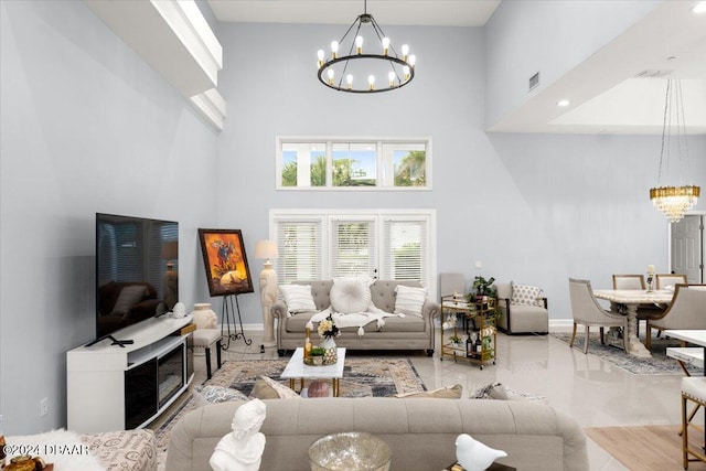 living room with a high ceiling and an inviting chandelier