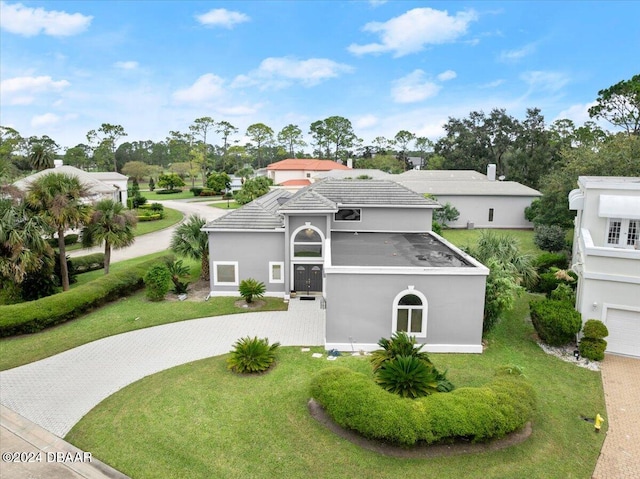 view of front of property with a garage and a front lawn