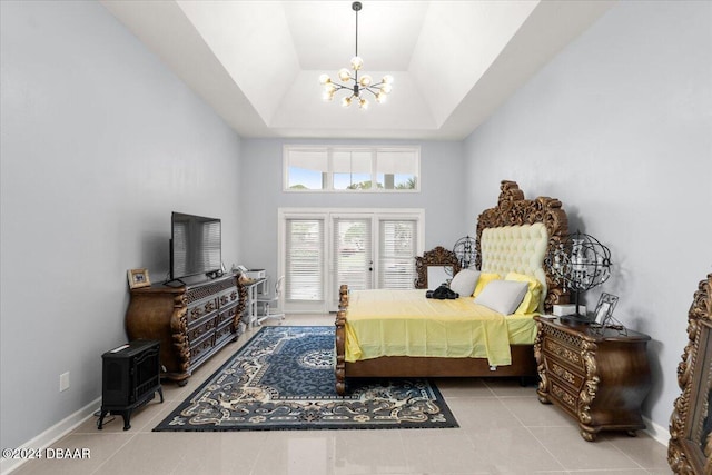 tiled bedroom with french doors, a notable chandelier, and a raised ceiling