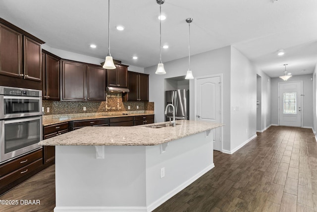 115 Pergola Pl, Ormond Beach, FL 32174 - kitchen featuring stainless steel appliances, dark wood finished floors, decorative backsplash, dark brown cabinetry, and recessed lighting